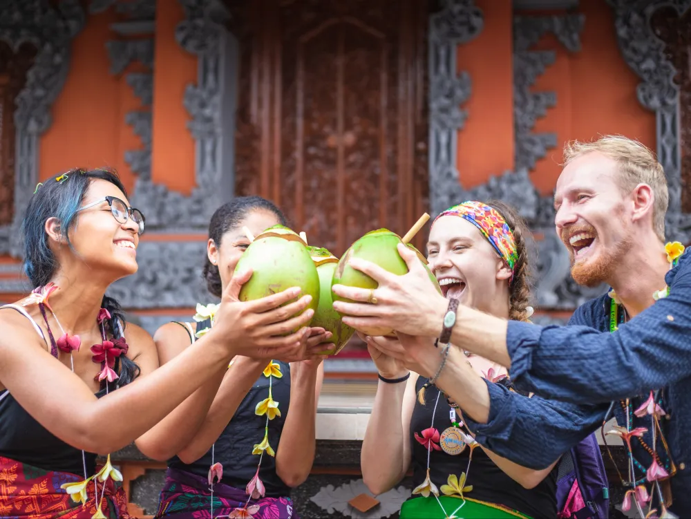 Sharing young coconuts with village hosts